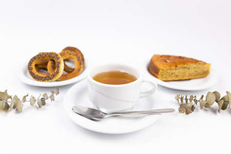 white tea set with teapot tea and saucers and pie for breakfastの写真素材