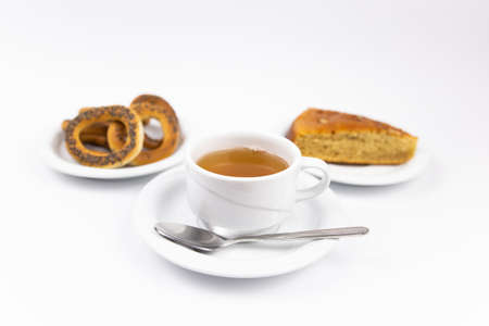 white tea set with teapot tea and saucers and pie for breakfastの写真素材