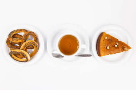 white tea set with teapot tea and saucers and pie for breakfast