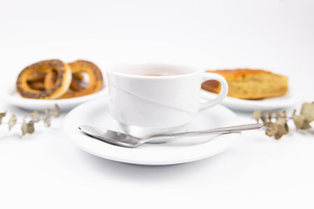 white tea set with teapot tea and saucers and pie for breakfastの写真素材