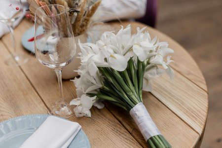 bride's bouquet on the table in the restaurant at the weddingの写真素材