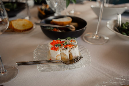 an appetizer with red caviar in the restaurant on the tableの写真素材
