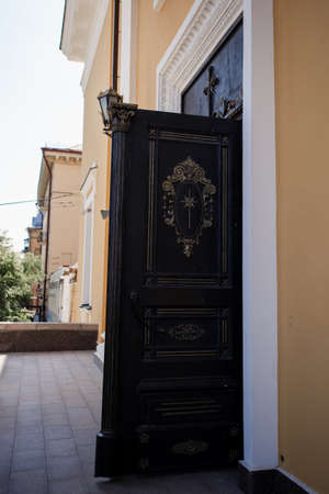 a beautiful old metal door to a catholic churchの写真素材