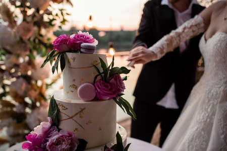 bride and groom at the wedding cutting the wedding cakeの写真素材