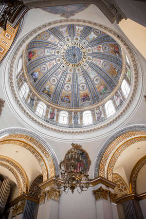 a round ceiling in a Catholic church with paintingの写真素材