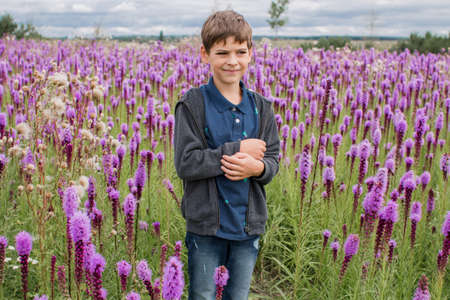 a boy in flowers in the garden in springの写真素材