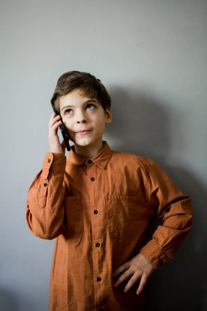 a little boy talking on a cell phone