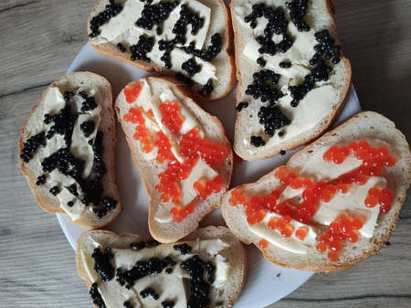 a sandwiches with red and black caviar on a plateの写真素材