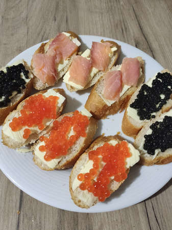a sandwiches with red and black caviar on a plateの写真素材