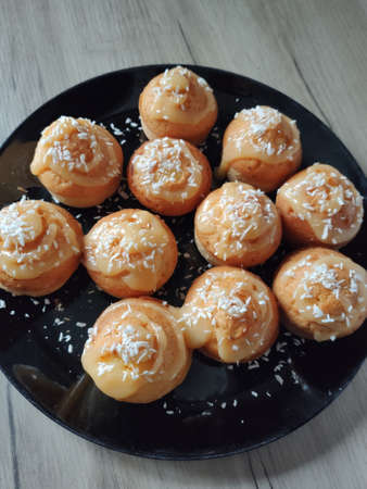 a delicious puffy cupcakes on a plate on the tableの写真素材