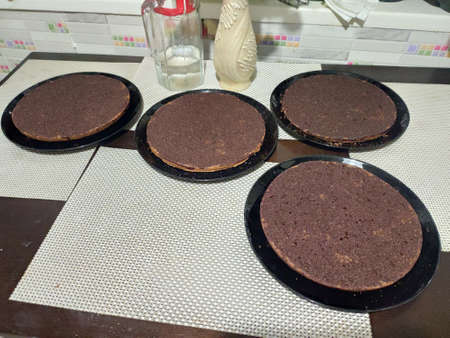 a chocolate biscuit cake layers on the kitchen tableの写真素材