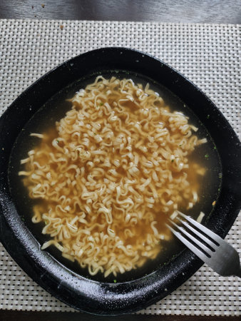 an instant pasta in a plate in the kitchenの写真素材