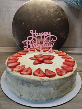 a strawberry birthday cake with white creamの写真素材