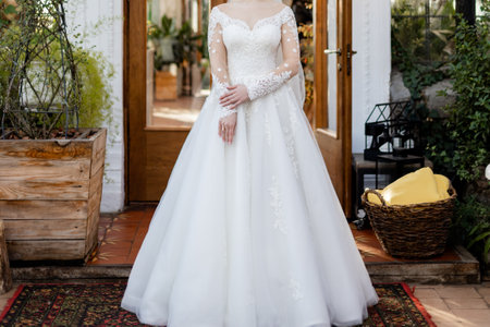 bride in a white wedding dress is waiting for the groom at the ceremonyの写真素材