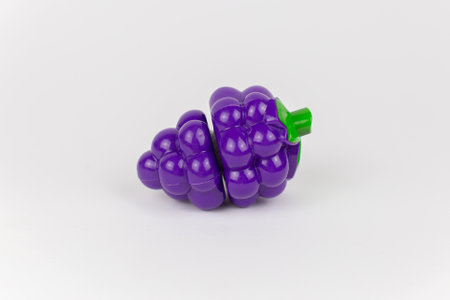 a plastic toy grapes on a white backgroundの写真素材