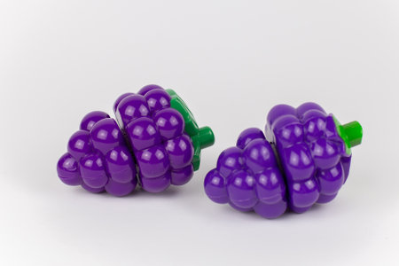 a plastic toy grapes on a white backgroundの写真素材