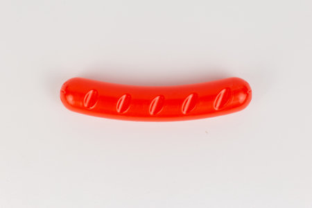 a plastic sausage grill children's toy on a white backgroundの写真素材