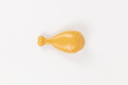 a chicken leg plastic toy child on a white backgroundの写真素材