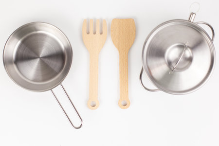 metal pan with a wooden spatula for cookingの写真素材