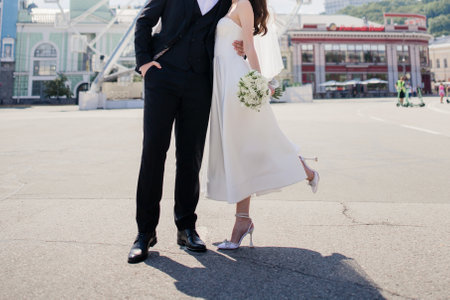 groom and the bride in a wedding dress together with a wedding bouquetの写真素材