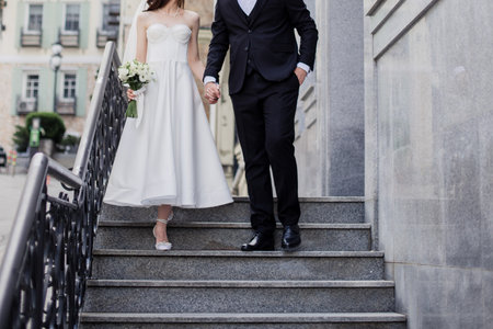 groom and the bride in a wedding dress together with a wedding bouquetの写真素材