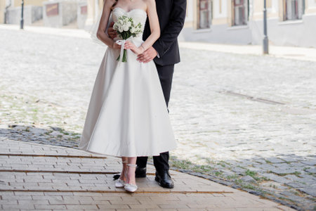 groom and the bride in a wedding dress together with a wedding bouquetの写真素材
