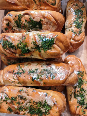 a fresh delicious baguette rolls with garlic dill and herbs in the bakeryの写真素材