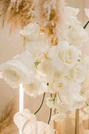 a decorative wedding party indoor wall of flowers with yellow lightの写真素材