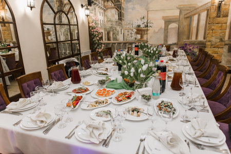 a wedding party banquet table with food and drinks for the birthdayの写真素材