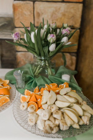 a decor from a bouquet of flowers on a festive buffet table in a restaurant on a wedding birthdayの写真素材