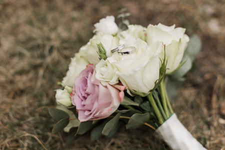 a wedding bouquet of the bride with wedding ringsの写真素材