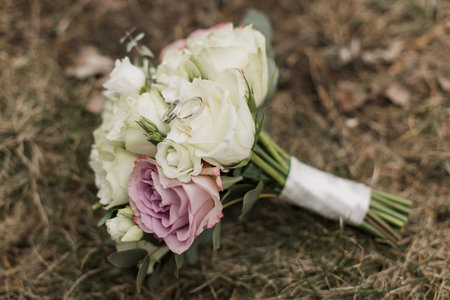 a wedding bouquet of the bride with wedding ringsの写真素材