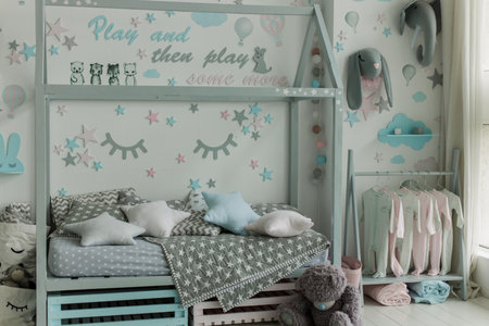 a gray children's bed in a children's room with toys and decorの写真素材