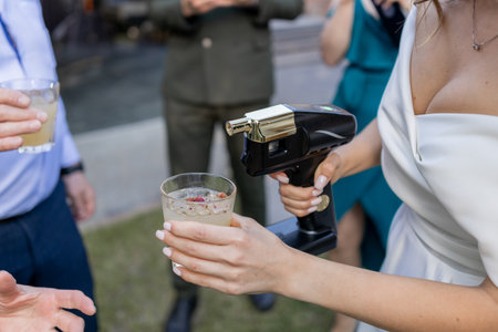 a bartender shows at a wedding with a bride in a dressの写真素材