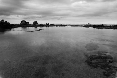 Black and white sunset on legon pari beach in sawarna in the late afternoonの写真素材