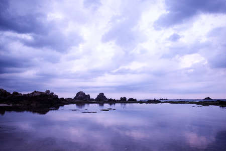 Purple sunset on legon pari beach in sawarna in the late afternoon