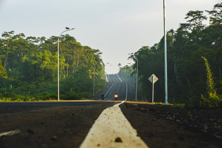 Portrait of a highway in the morning in a small town with sunlight