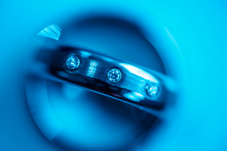 Diamond ring on blue background. Jewelry concept. Macro shot.