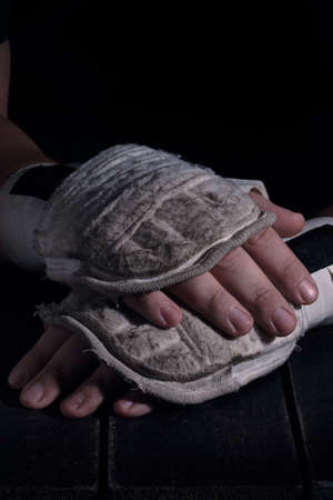Close up of hands of martial fighter with boxing equipment donned. Ready to fight concept.の写真素材