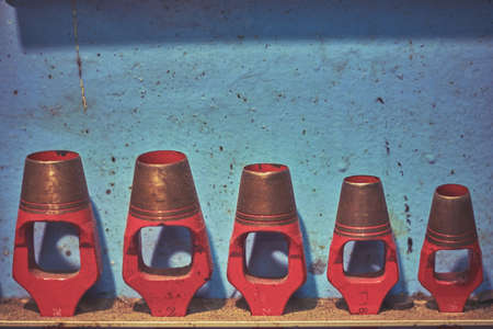 Blue rustic shelf with plenty hanging red hole punchersの写真素材