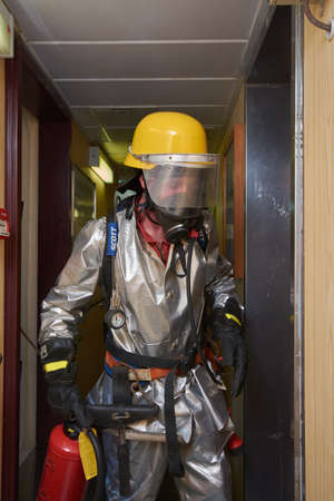 At sea - September 2018: International ship's crew performing monthly fire drill exercise onboard...