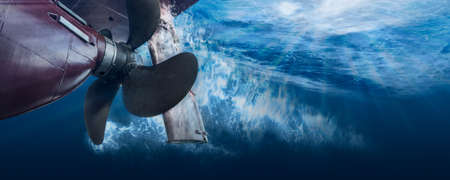 Propeller and rudder of big ship underway view from underwater. Close up image detail of ship....