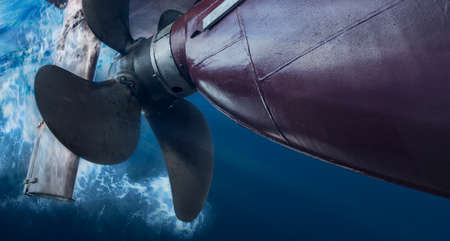 Propeller and rudder of big ship underway view from underwater. Close up image detail of ship....