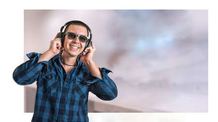 Man with headphones on pastel background. Black headphones. Leisure concept. Technology background....