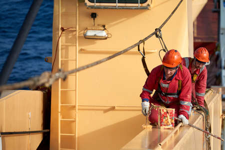 Atlantic Ocean, Open Sea - Circa March 2019: International Ships Crew Performing working aloft,...