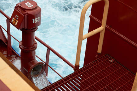 View of ballast water exchange process onboard of a ship using flow-through method underway in open...