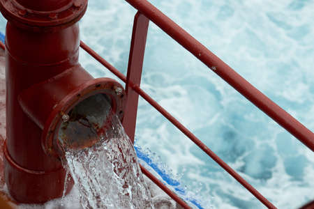 View of ballast water exchange process onboard of a ship using flow-through method underway in open...