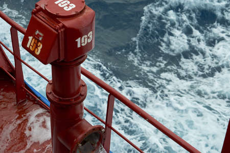 View of ballast water exchange process onboard of a ship using flow-through method underway in open...