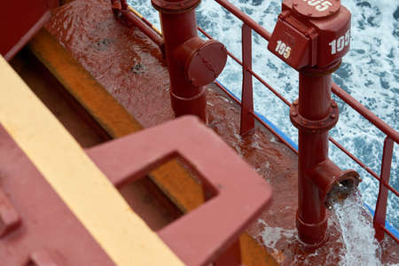 View of ballast water exchange process onboard of a ship using flow-through method underway in open...