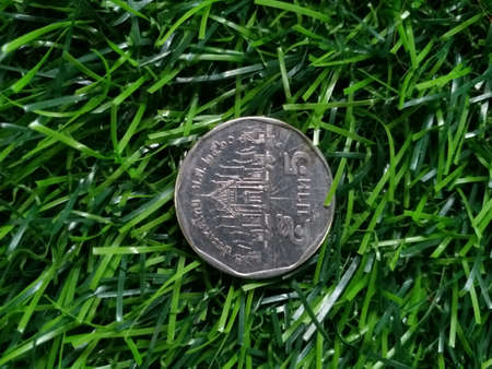 Thai 5 baht coin on artificial grass backgroundの写真素材